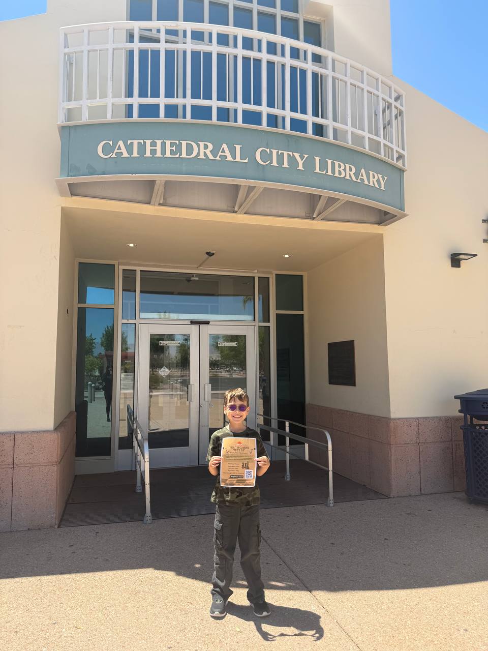 Keith smiling in front of Cathedral City Library after dropping off flyers for the new chess club.